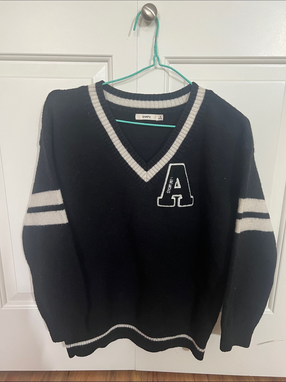 Black V-Neck Sweater with White Trim and Letter Patch